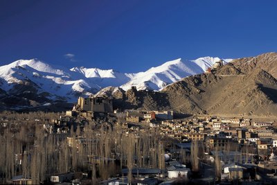 Umgeben von weißen Schneebergen befindet sich die Stadt Leh