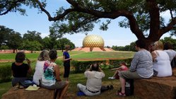gruppenreise-suedindien-auroville-lisa-thole-matrimandir Reiseleiterin Lisa Thole mit einer Gruppe vor dem Matrimandir in Auroville