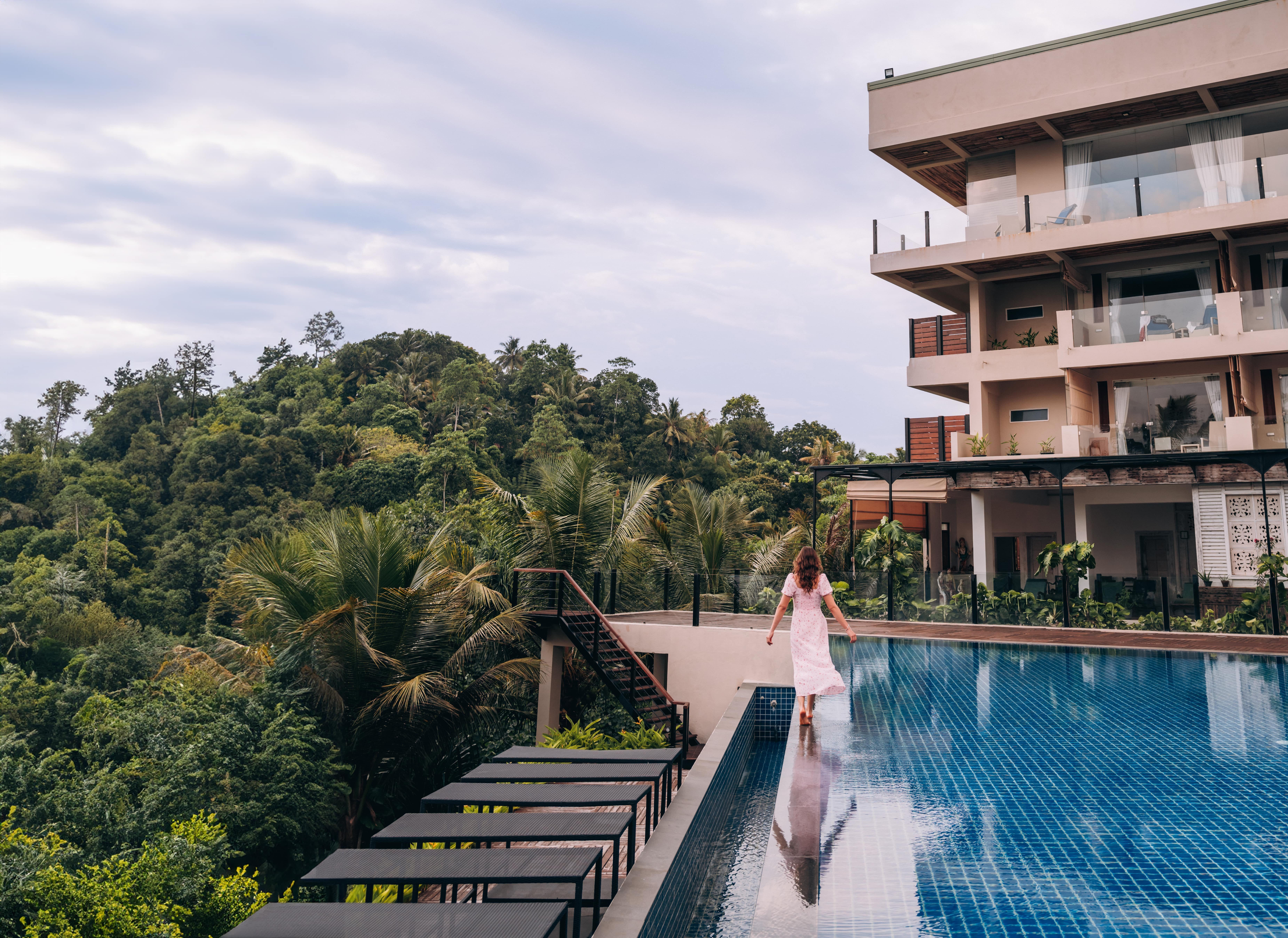 Eine Frau läuft auf dem Rand eines Pools