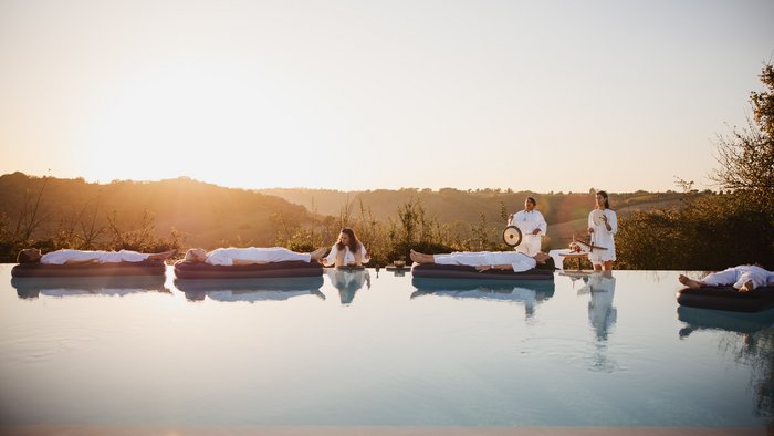 Vier Ayurveda-Gäste nehmen an einer Klang-Meditation auf dem Wasser teil