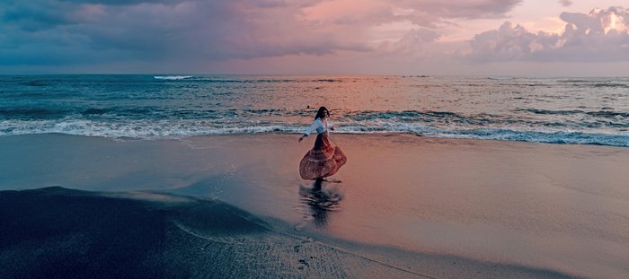 Frau Tanz am Strand bei Sonnenuntergang