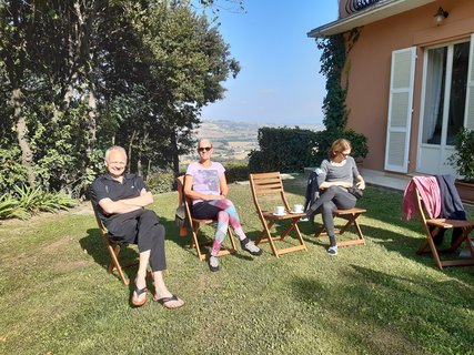 Die Reisegruppe genießt die Sonne im Garten der Villa Garulli